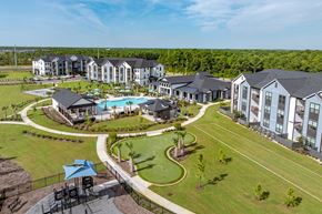 Southport apartment for rent - Drone photo of the property with pool, golf course and playground.