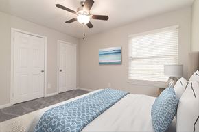 Greensboro apartment for rent - a bedroom with a large bed and a ceiling fan