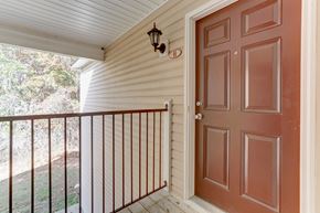 Fayetteville apartment for rent - A brown door is on the right side of a white wall.