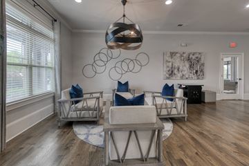 Pike Road apartment for rent - A modern living room with a large chandelier and a painting on the wall.