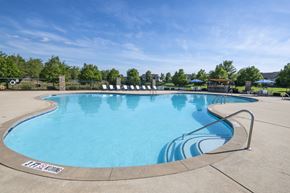 Pike Road apartment for rent - A large outdoor swimming pool with a metal railing around it.