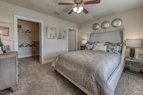Pike Road apartment for rent - A bedroom with a large bed and a ceiling fan.