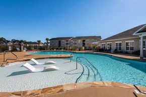 Fayetteville apartment for rent - a large swimming pool with a building in the background