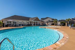 Fayetteville apartment for rent - a large swimming pool with a house in the background