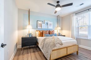 Summerville apartment for rent - A bedroom with a bed, nightstands, and a ceiling fan.