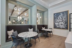Wake Forest apartment for rent - A dining area with round tables and bench seating.