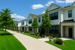 Charlotte townhouse for rent - A row of houses with green lawns and trees.