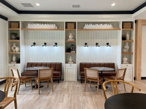 Sneads Ferry apartment for rent - a dining room with tables and chairs and a wall with shelves