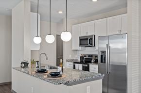 Cornelius apartment for rent - A modern kitchen with granite countertops and stainless steel appliances.