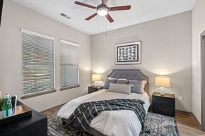 Cornelius apartment for rent - A bedroom with a bed, nightstands, and a ceiling fan.