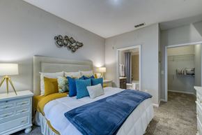 Orange City apartment for rent - A bedroom with a white bed and yellow accents.