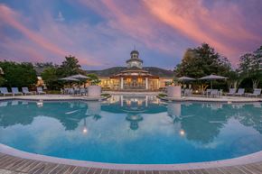 Palm Coast apartment for rent - A beautiful pool with a building in the background at dusk.
