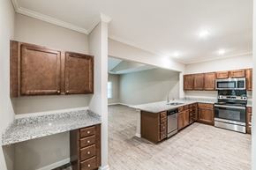 Madison apartment for rent - A kitchen with brown cabinets and a granite countertop.