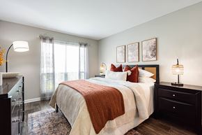 Charleston apartment for rent - A bedroom with a large bed and a window with curtains.