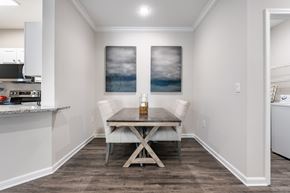 Columbia apartment for rent - A dining room with a table and chairs and a painting on the wall.