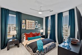 Wellford apartment for rent - A bedroom with a bed, nightstand, and a ceiling fan.