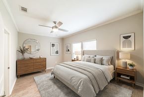 Madison apartment for rent - A bedroom with a large bed, a dresser, and a mirror.