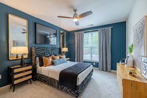 Chapel Hill apartment for rent - A bedroom with a bed, dresser, and mirror.