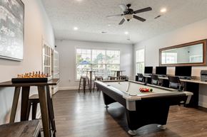 Fayetteville apartment for rent - a game room with a pool table and a bar with chairs