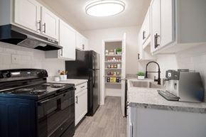 Greensboro apartment for rent - a kitchen with black appliances and white cabinets