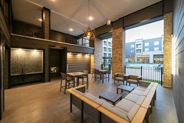 Huntsville apartment for rent - A modern living room with a long wooden table and chairs.