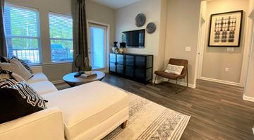 Pooler apartment for rent - A living room with a white couch and a black and white striped throw pillow.