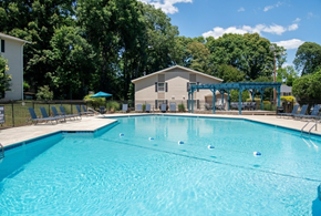 Greensboro apartment for rent - A large swimming pool with a building in the background.