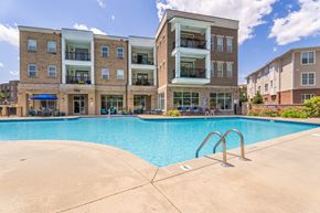 Holly Springs apartment for rent - a swimming pool with an apartment building in the background