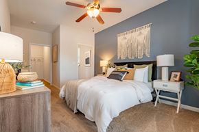 Holly Springs apartment for rent - a bedroom with a large bed and a ceiling fan