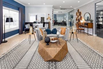 Jacksonville apartment for rent - A modern living room with a wooden coffee table in the center.