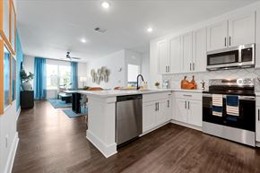Wildwood apartment for rent - A modern kitchen with white cabinets and stainless steel appliances.