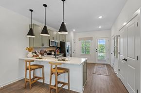 Weaverville townhouse for rent - A kitchen with a white counter and wooden bar stools.