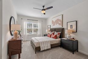 Weaverville townhouse for rent - A bedroom with a bed, nightstand, and a ceiling fan.