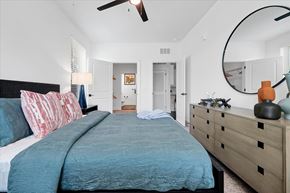 Wildwood apartment for rent - A bedroom with a large bed and a dresser.