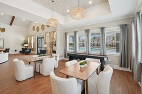 Shallotte apartment for rent - a dining room with a table and chairs and a piano