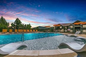 Asheville apartment for rent - A large outdoor swimming pool with chairs and loungers.