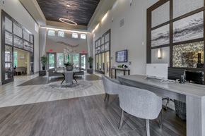 Jacksonville apartment for rent - A modern office space with a large desk and chairs.