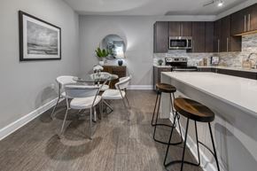 Jacksonville apartment for rent - A modern kitchen with a dining table and chairs.