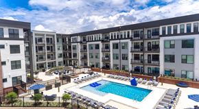 Winston Salem apartment for rent - a swimming pool in front of an apartment building