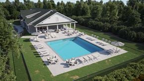 Calabash apartment for rent - a yard with a swimming pool and patio furniture in front of a house