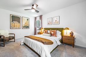 Greensboro apartment for rent - a bedroom with a bed and a ceiling fan