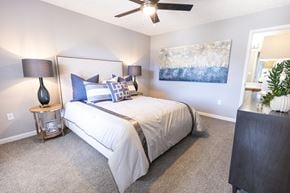 Montgomery apartment for rent - A bedroom with a bed, two lamps, and a painting on the wall.