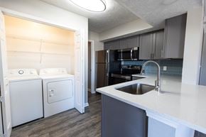 Montgomery apartment for rent - A kitchen with a white counter top and a black refrigerator.