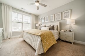 Fuquay-Varina apartment for rent - a bedroom with a bed and a ceiling fan