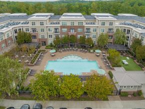 Cary apartment for rent - an aerial view of a large swimming pool in front of an apartment building