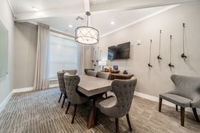 Fuquay-Varina apartment for rent - a dining room with a table and chairs and a tv