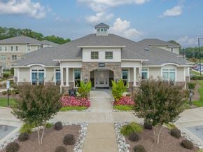 Apex apartment for rent - a large house with a driveway and landscaping in front of it