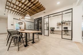 Wake Forest apartment for rent - a dining area with a wooden table and chairs and a kitchen with glass doors