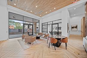 Cary apartment for rent - A modern living room with a wooden floor and a glass wall.