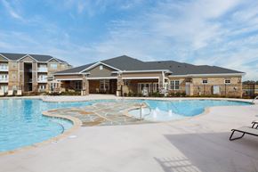 Winterville apartment for rent - A large swimming pool in front of a building.